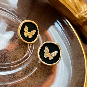 French vintage butterfly metal stud earrings with matte gold relief and black round base