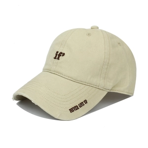 Detail of beige baseball cap with 'if' embroidery and distressed frayed brim edges
