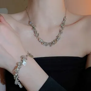 Silver teardrop filigree necklace and bracelet jewelry set for women on model