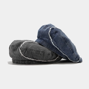 Distressed wash denim beret with frayed edges in navy blue and dark grey colors