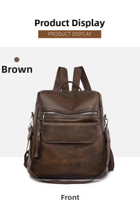 Detail view of the brown PU leather texture and front zipper pocket with decorative tassel