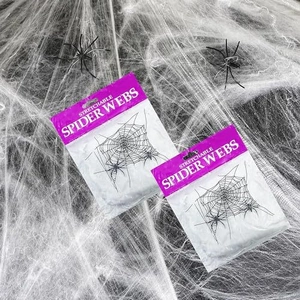 Two packs of white stretchable Halloween spider webs with small black plastic spiders