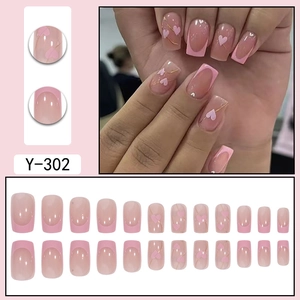Detail view of pink French press-on nails Y-302 with gold lines and white hearts