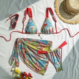 Detail of red paisley three-piece bikini set with matching sarong and adjustable ties