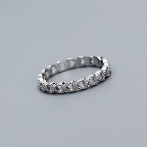 Macro shot of 925 sterling silver ring featuring continuous hollow heart shaped patterns