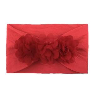 Detailed view of three red chiffon flowers on a soft nylon baby headband
