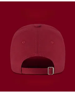 Detail of adjustable metal buckle and burgundy cotton fabric on the back of baseball cap