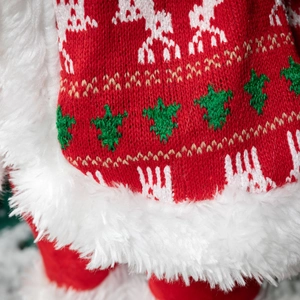 Christmas Santa doll with knitted reindeer and tree patterns and white faux fur trim