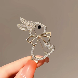 Cute bunny brooch with sparkling crystals and golden bow tie detail for women