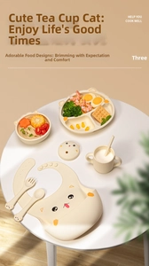 Close-up of cat-shaped baby silicone tableware set including suction plate, bowl and bib