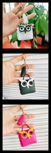 Close-up of owl-shaped mini purses with tassels and gold keychains in three colors