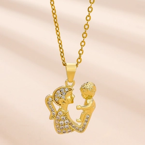 Gold mother and child necklace with sparkling zircon pave set on pink silk background