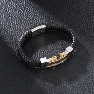Detail of black woven leather bracelet with silver magnetic clasp and metal screw accents