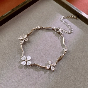 Detailed view of silver zircon flower bracelet with wavy links and adjustable lobster clasp