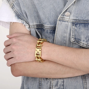 Close-up of 18mm golden motorcycle chain bracelet for men with industrial H-clasp