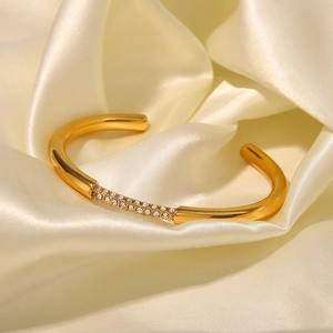Dettaglio del bracciale aperto placcato oro 18K con zirconi su tessuto di seta