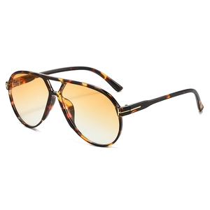 Vintage pilot sunglasses with tortoiseshell frame, orange gradient lenses, and gold T logo