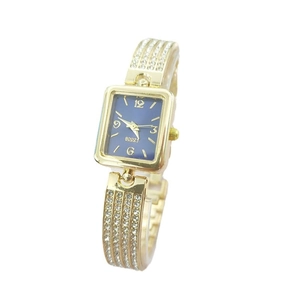 Macro detail of luxury square gold watch with blue dial and sparkling crystal rhinestones