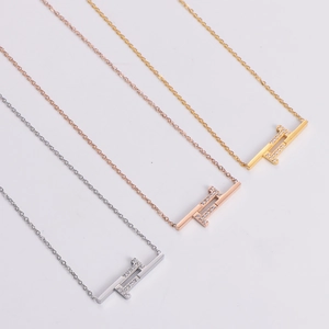 Three minimalist double T pendant necklaces in silver, rose gold, and gold plating