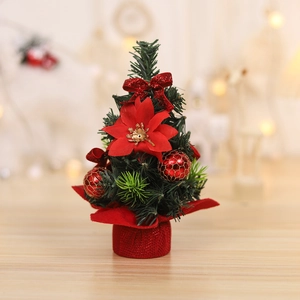 Mini tabletop Christmas tree with red poinsettia, glitter bow and pine needles decor