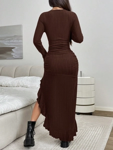 Detail view of coffee brown ribbed dress showing slim fit and asymmetric ruffled hemline