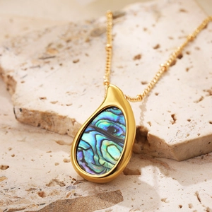 Macro shot of 18k gold plated stainless steel teardrop pendant with abalone shell inlay