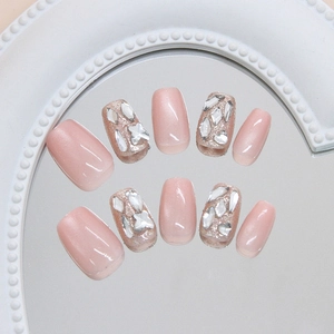 Handmade press-on nails in sheer pink cat eye design with luxury rhinestones and stars