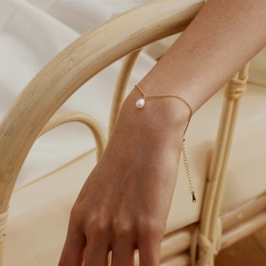 Close-up of 18K gold plated stainless steel bracelet with freshwater pearl on wrist