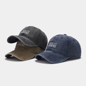 Three washed cotton baseball caps in grey green and blue with white embroidery detail