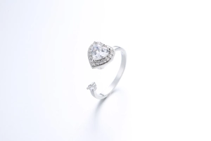 Detail of silver spinner ring with heart zircon and adjustable open band design