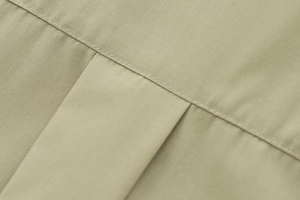 Detail view of khaki poplin shirt fabric with premium stitching and smooth texture