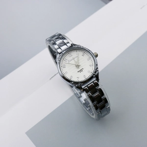 Detail of quartz watch with white numeric dial and textured gunmetal alloy link band