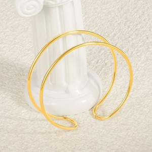 Minimalist double layer 18k gold plated stainless steel open bangle on white column
