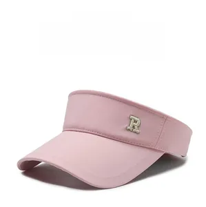 Detailed side view of pink sun visor with metal letter R decoration and stitching