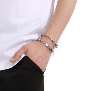 Close-up of thick square-line stainless steel chain bracelet on a male wrist