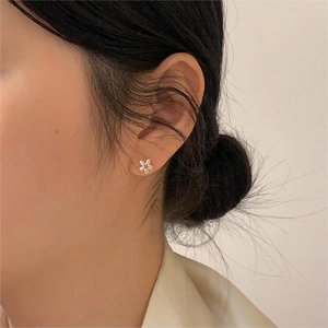 Minimalist 925 sterling silver flower stud earrings worn on model for elegant daily style