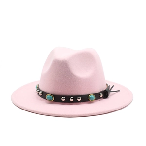 Detail of pink wool fedora featuring black band with turquoise stones and silver rivets