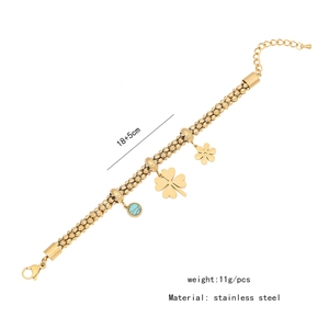 Detail of gold stainless steel flower bracelet with clover and teal bead charms