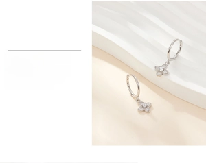 Detail of 925 silver clover earrings featuring layered plating and zircon stones