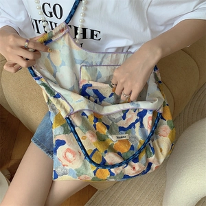 Floral oil painting tote bag showing textured fabric, drawstring and pearl charm