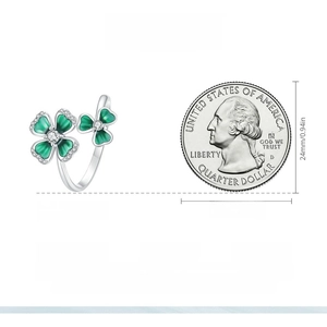 Size comparison of silver clover ring with green enamel against a 25-cent coin