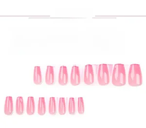 Detailed flat lay of pink gradient press-on nails in various sizes with glossy finish