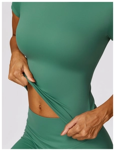Close-up view of dark green yoga set showing high elasticity and soft matte fabric texture