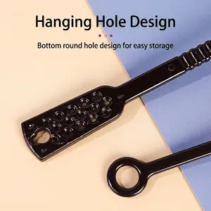 Black plastic measuring spoon with long handle and hanging hole for coffee or milk powder