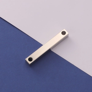 Detailed view of silver rectangular titanium steel bar with dual holes for DIY jewelry