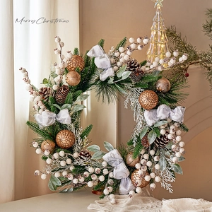 Christmas wreath with pine cones and golden baubles on a cozy festive tabletop