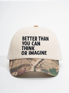 Detail of baseball cap with cream crown and camo brim featuring embroidered BETTER THAN text