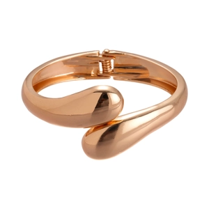 Polished rose gold geometric crossover bangle with spring opening on white background