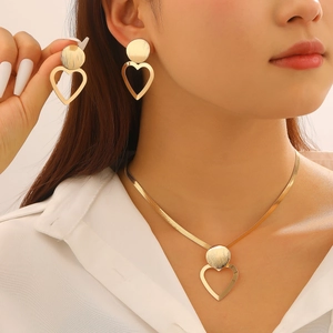 Elegant gold heart pendant necklace and earrings set with brushed metal texture