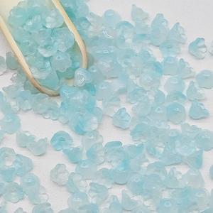 Macro shot of lily of the valley glass beads in gradient blue for DIY jewelry making